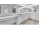 Bright bathroom features marble counters, white cabinets, and a large mirror at 4200 N Miller Rd # 325, Scottsdale, AZ 85251