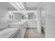 Bright bathroom features marble counters, white cabinets, and a large mirror at 4200 N Miller Rd # 325, Scottsdale, AZ 85251
