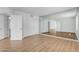 Bright bedroom with light wood floors, large mirror, and double door closet at 4200 N Miller Rd # 325, Scottsdale, AZ 85251