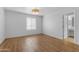 Bright bedroom features stylish wood floors, a window, and an attached bathroom for easy access at 4200 N Miller Rd # 325, Scottsdale, AZ 85251