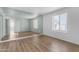 Bright bedroom features stylish wood floors, a window, and a large mirror at 4200 N Miller Rd # 325, Scottsdale, AZ 85251