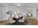 Open-concept dining area flowing into a kitchen with white cabinetry and stainless steel appliances at 4200 N Miller Rd # 325, Scottsdale, AZ 85251
