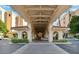Grand covered entrance showcasing beautiful architecture and lush landscaping, providing a welcoming arrival experience at 4200 N Miller Rd # 325, Scottsdale, AZ 85251