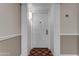 A white entrance door with decorative hardware inside a condo building, unit number 325 at 4200 N Miller Rd # 325, Scottsdale, AZ 85251