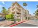 Beautiful multi-story condo with manicured landscaping, palm trees, and an attractive entryway at 4200 N Miller Rd # 325, Scottsdale, AZ 85251