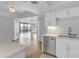 Bright kitchen area with wood floors, quartz countertops, stainless steel appliances, and balcony access at 4200 N Miller Rd # 325, Scottsdale, AZ 85251