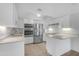 Bright, modern kitchen features stainless steel appliances, white cabinetry, and quartz countertops at 4200 N Miller Rd # 325, Scottsdale, AZ 85251