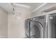 Laundry room featuring front load washer and dryer and built-in shelving at 4200 N Miller Rd # 325, Scottsdale, AZ 85251