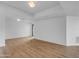 Living room with hardwood floors, bright lights, white walls, and a large window at 4200 N Miller Rd # 325, Scottsdale, AZ 85251