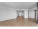 Spacious living area with wood floors and an open layout leading to the kitchen and hallway at 4200 N Miller Rd # 325, Scottsdale, AZ 85251