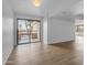 Spacious living room with hardwood floors, white walls, and a balcony view at 4200 N Miller Rd # 325, Scottsdale, AZ 85251