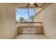 Serene balcony featuring decorative lattice and views of lush greenery and the community's architecture at 4200 N Miller Rd # 325, Scottsdale, AZ 85251