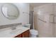 Cozy bathroom with a vessel sink, round mirror, and tiled shower at 440 S Val Vista Dr # 11, Mesa, AZ 85204