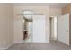 Carpeted bedroom showcasing a sliding barn door and an open doorway to the bathroom at 440 S Val Vista Dr # 11, Mesa, AZ 85204