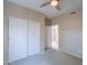 Bedroom with a ceiling fan, closet and an entry way to another room at 440 S Val Vista Dr # 11, Mesa, AZ 85204