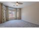 Cozy bedroom with soft carpet, ceiling fan, and bright windows with decorative curtains at 440 S Val Vista Dr # 11, Mesa, AZ 85204