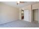 Carpeted bedroom with a bathroom view, showcasing a sliding barn door and an open doorway at 440 S Val Vista Dr # 11, Mesa, AZ 85204