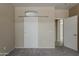 Neutral bedroom features a stylish white sliding barn door and a view into another room at 440 S Val Vista Dr # 11, Mesa, AZ 85204