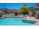Community pool with chairs, green landscaping, and plenty of sunshine at 440 S Val Vista Dr # 11, Mesa, AZ 85204