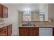 Bright, open kitchen featuring wooden cabinetry, granite countertops, and stylish tiled backsplash at 440 S Val Vista Dr # 11, Mesa, AZ 85204