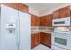 Bright kitchen showcasing wooden cabinets, modern white appliances, and ample counter space at 440 S Val Vista Dr # 11, Mesa, AZ 85204