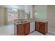 Well-lit kitchen featuring wooden cabinetry, granite countertops, and an open-concept layout for seamless entertaining at 440 S Val Vista Dr # 11, Mesa, AZ 85204