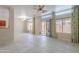 Spacious living room with neutral tile flooring and large windows with decorative curtains at 440 S Val Vista Dr # 11, Mesa, AZ 85204