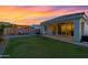 Inviting backyard with a pergola-covered seating area, lawn, and covered patio at sunset at 4543 S Nebula --, Mesa, AZ 85212