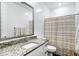 Bright bathroom featuring granite countertops, white cabinets, and a large vanity mirror at 4543 S Nebula --, Mesa, AZ 85212
