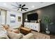 Cozy living room features a ceiling fan, black accent wall, and comfortable seating at 4543 S Nebula --, Mesa, AZ 85212