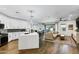 Open-concept living room and kitchen area with modern lighting and wood-look flooring throughout at 4543 S Nebula --, Mesa, AZ 85212