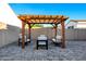 Backyard seating area with a stylish wooden pergola and comfortable furniture at 4543 S Nebula --, Mesa, AZ 85212