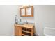 Bright bathroom with wooden vanity, glass vessel sink, and mirrored cabinet at 4800 N 68Th St # 357, Scottsdale, AZ 85251