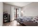 Cozy bedroom featuring a private balcony, wood floors, and stylish decor at 4818 E Hazel Dr # 1, Phoenix, AZ 85044
