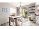Cozy dining room with modern chandelier, stylish table, and view of the backyard at 4818 E Hazel Dr # 1, Phoenix, AZ 85044