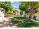Well-maintained front yard featuring lush lawn and mature trees providing shade at 4818 E Hazel Dr # 1, Phoenix, AZ 85044