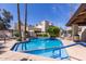 Community pool featuring clear blue water, surrounded by palm trees and lounge chairs at 4818 E Hazel Dr # 1, Phoenix, AZ 85044