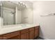 Bathroom with wood cabinets, a large mirror, and shower-tub combination featuring a tiled surround at 4925 S 5Th Ave, Phoenix, AZ 85041