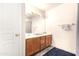 Bathroom features a wood vanity with a sink, a mirror, and wood-look floors at 4925 S 5Th Ave, Phoenix, AZ 85041