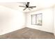 This bedroom features a neutral color palette, carpeted floors, and a ceiling fan for comfort at 4925 S 5Th Ave, Phoenix, AZ 85041