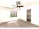 Bright bedroom features a ceiling fan, a window, and neutral carpet at 4925 S 5Th Ave, Phoenix, AZ 85041