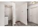Hallway featuring tile flooring, laundry closet with washer, and nearby storage space at 4925 S 5Th Ave, Phoenix, AZ 85041