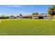 Large backyard with a pool, patio, green space, and mature landscaping at 5112 E Cholla St, Scottsdale, AZ 85254