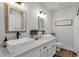 Bright bathroom boasts dual sinks, decorative mirrors, and a modern design for a spa-like experience at 5112 E Cholla St, Scottsdale, AZ 85254