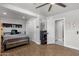 Spacious bedroom with hardwood floors, a ceiling fan, and a convenient ensuite bathroom at 5112 E Cholla St, Scottsdale, AZ 85254