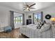 Cozy bedroom with patterned bedding, a ceiling fan, and view of the backyard pool at 5112 E Cholla St, Scottsdale, AZ 85254