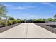 Long, paved driveway with mature landscaping and a security gate at 5112 E Cholla St, Scottsdale, AZ 85254