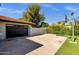 Attached, three-car garage with a driveway and adjacent basketball court at 5112 E Cholla St, Scottsdale, AZ 85254