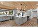Well-lit kitchen with gray cabinetry, quartz countertops, a large island, and stainless steel appliances at 5112 E Cholla St, Scottsdale, AZ 85254