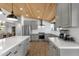 Modern kitchen features stainless steel appliances, quartz countertops, and wood look tile floors at 5112 E Cholla St, Scottsdale, AZ 85254